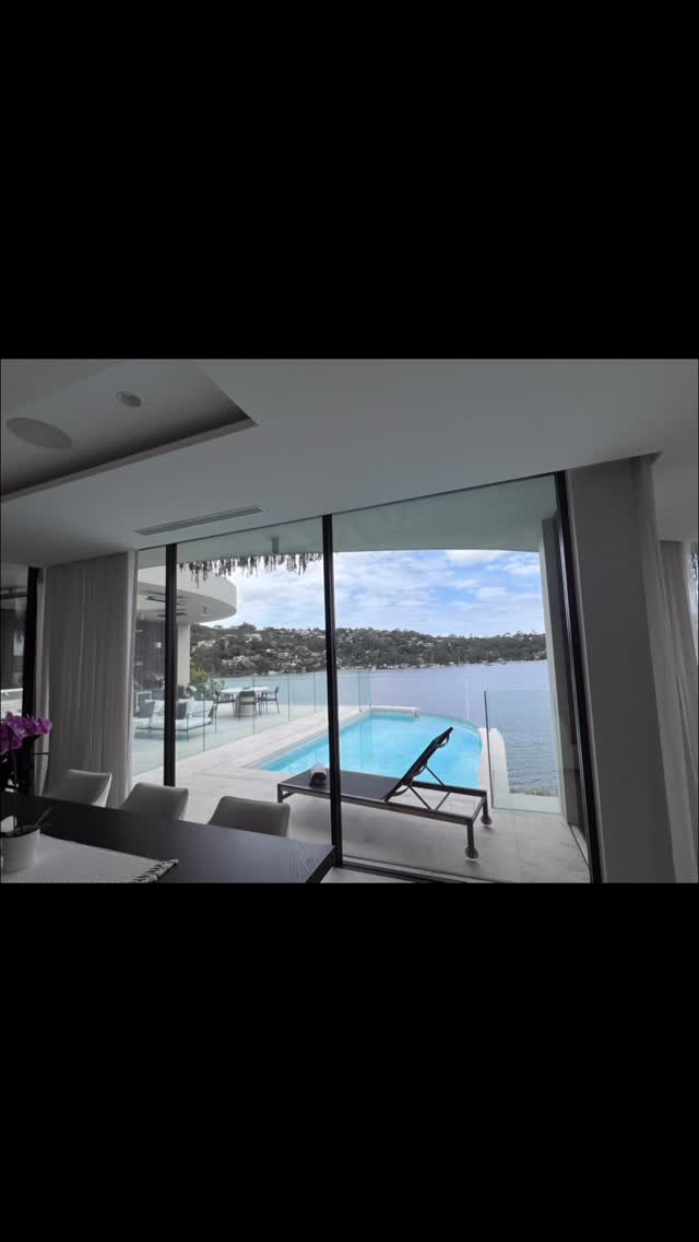 Waterfront home with pool, floor-to-ceiling glass cleaned